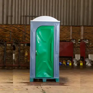 Green and white plastic portable toilet